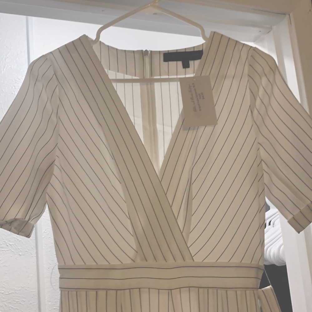 White and black striped jumpsuit, great material, never been worn, with tags.